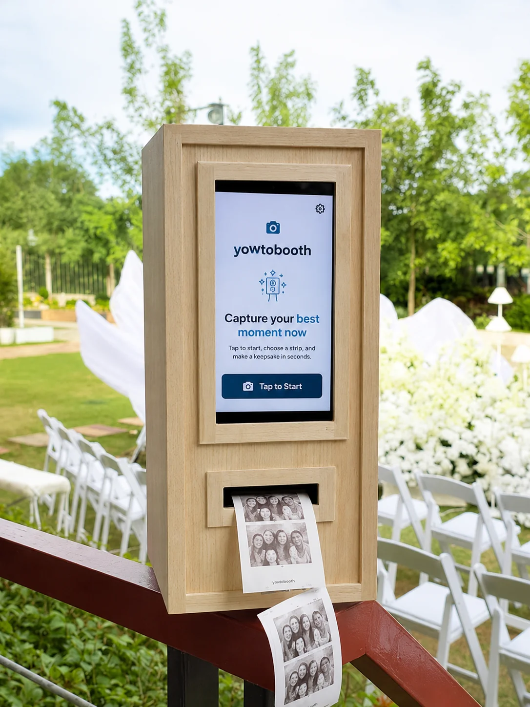 YowtoBooth wooden thermal receipt photobooth printing photo strips at an outdoor wedding event